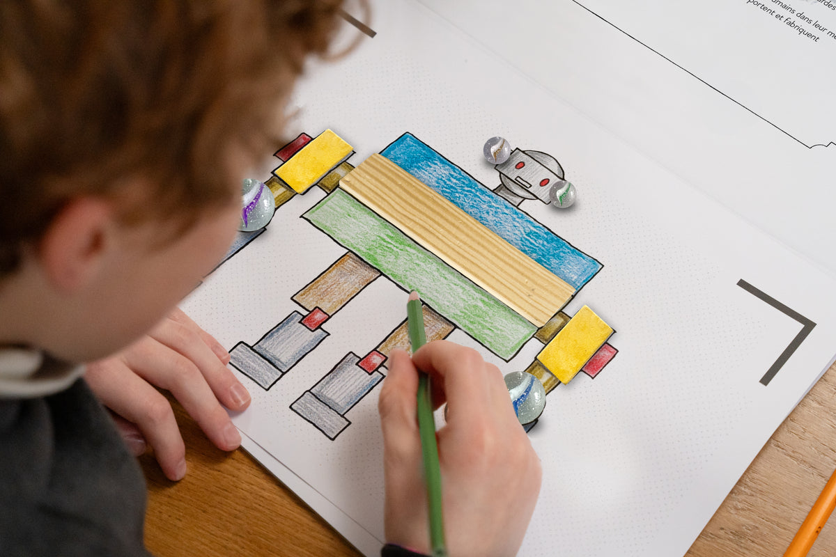 Enfant qui colorie un robot dans le cahier BlinkBook Les Robots